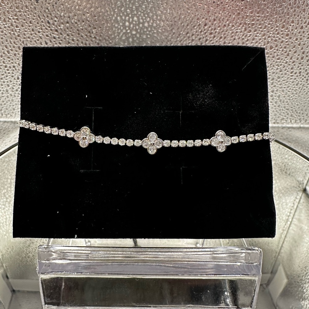 This bracelet is silver over brass with beautiful CZs and is adjustable.